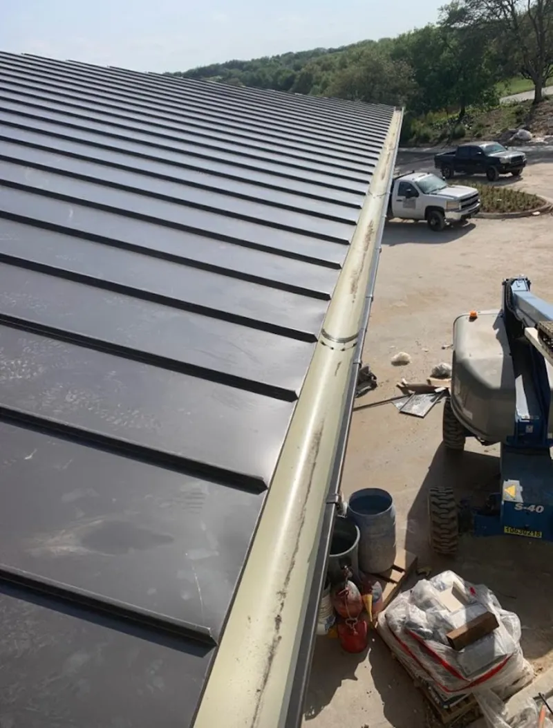 Standing seam panel and gutter detail on a metal roofing jobsite in Union